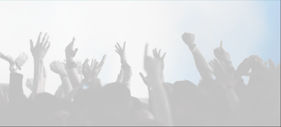 Hands reaching up at a concert.